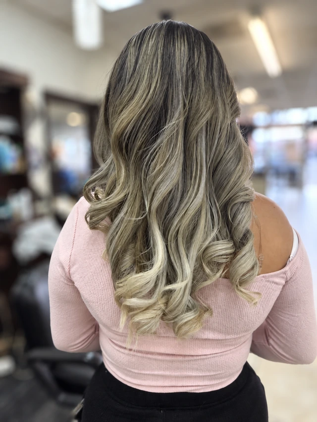 Long blonde highlighted curls viewed from behind