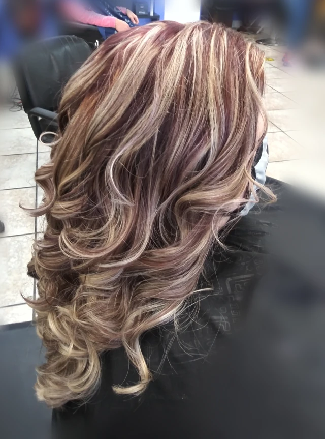 Long highlighted curls viewed from the side