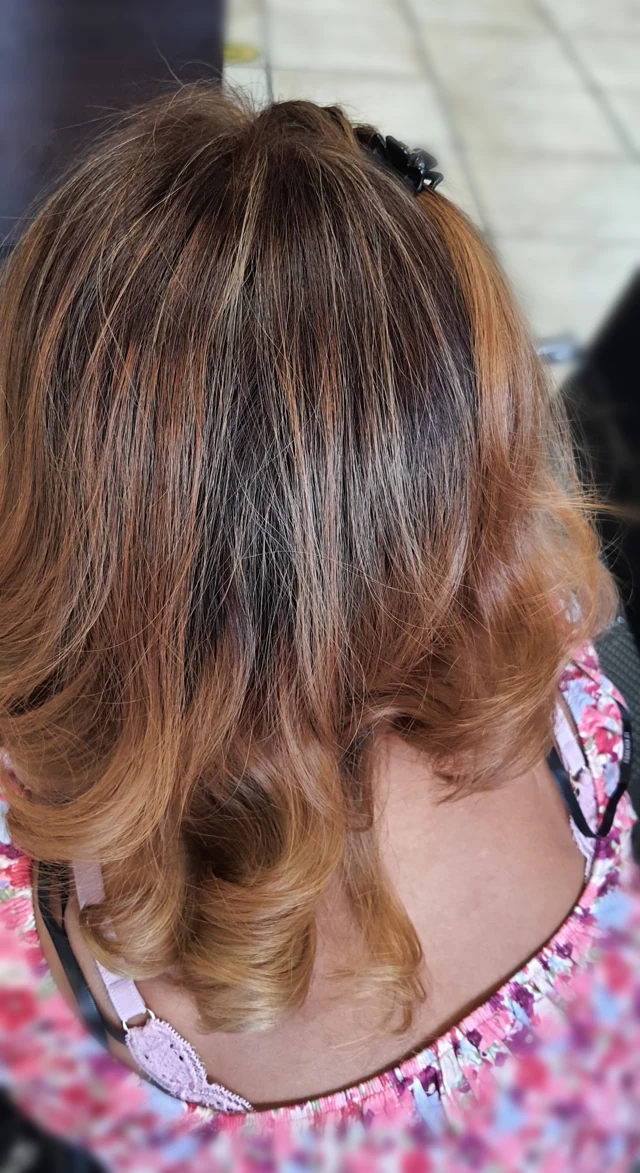 Layered shoulder-length hair with warm highlights
