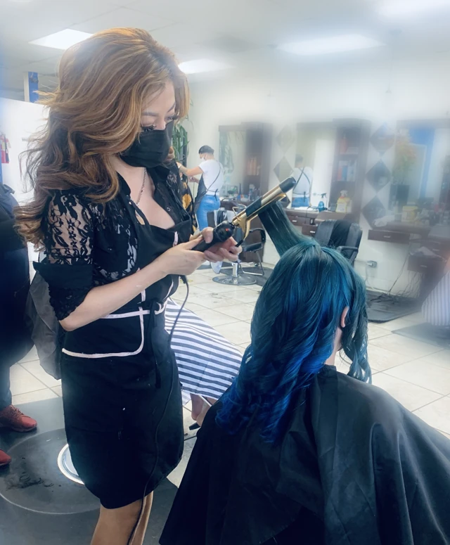 Stylist curling blue hair
